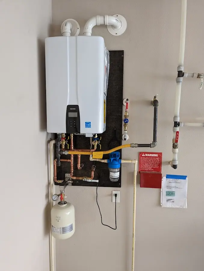 Professional plumber installing copper piping in a Trumbull home